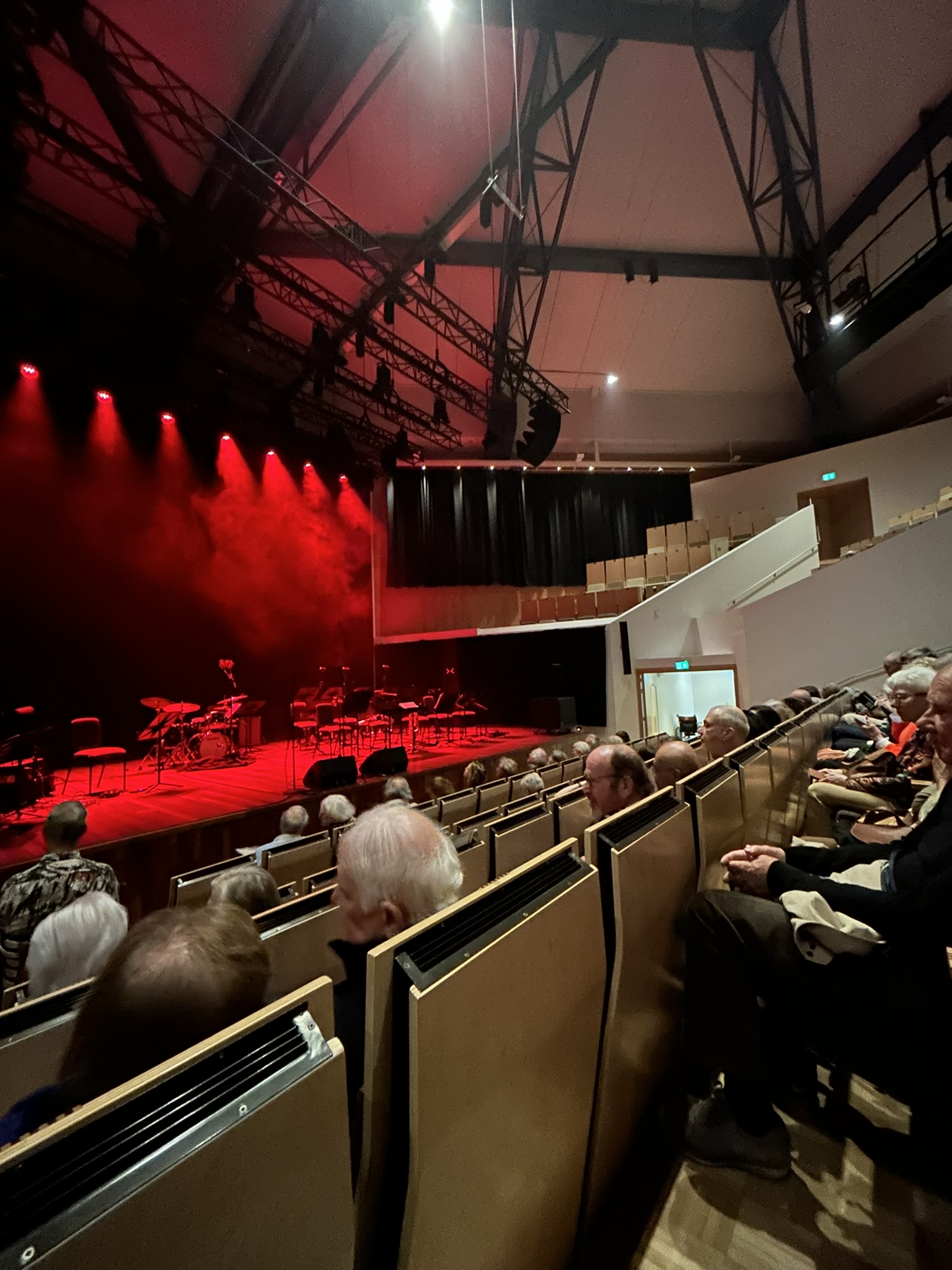View of the Fontys Bigband on stage from the audience, red stage lighting
